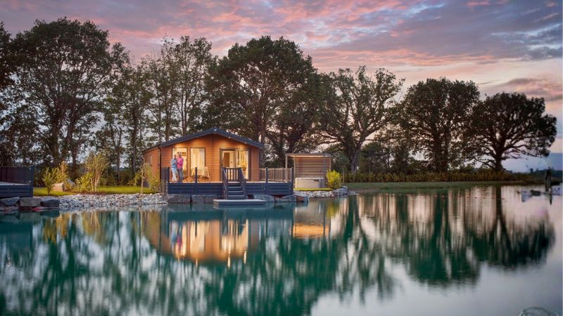 A couple relaxing in their holiday lodge at Green Meadow, Aberystwyth
