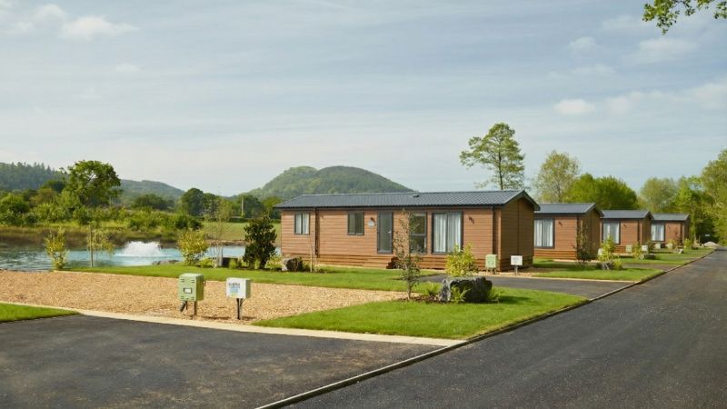 Modern holiday lodges at Spring Lea Holiday Park with views of the Shropshire Hills and the lake