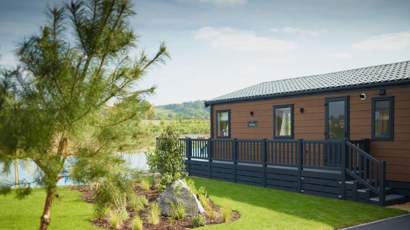 Luxury holiday lodge with wrap-around decking and countryside views at Green Meadow Holiday Park, Mid Wales