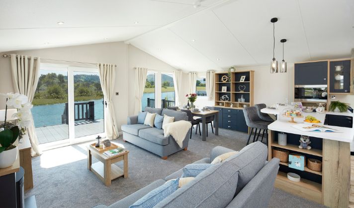 Modern open-plan interior of a new static caravan with coastal views